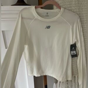New Balance Women’s top. NWT. Sea salt color. Retail $50. Size large. 100%nylon